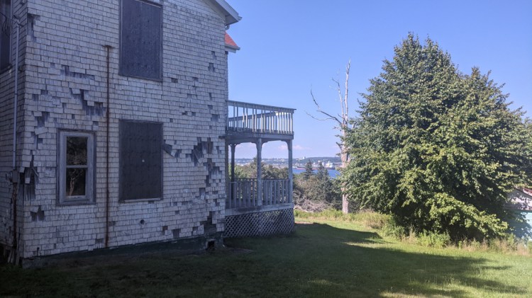 Shingles are missing on this abandoned house