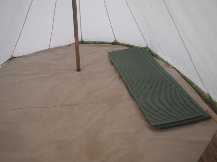 a triangular tent with floor mats