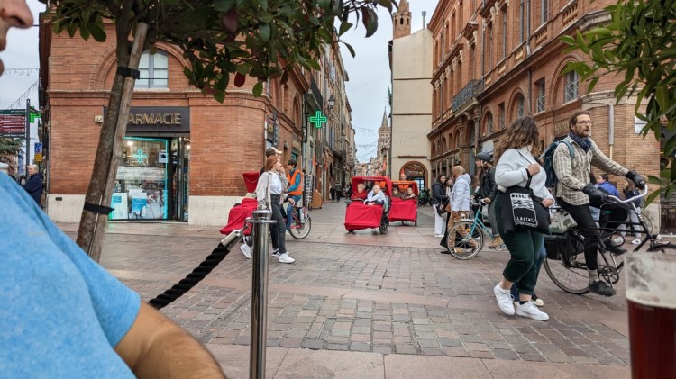 View of several modes of active transportation while having a beer at the Capitole in Toulouse
