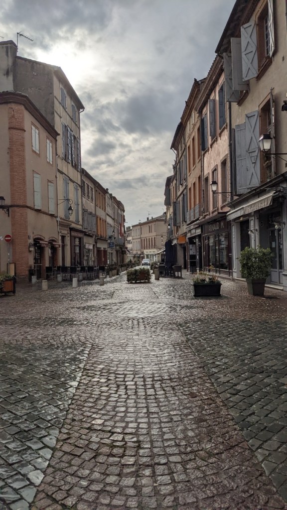 Downtown Moissac showing narrow cobblestone streets