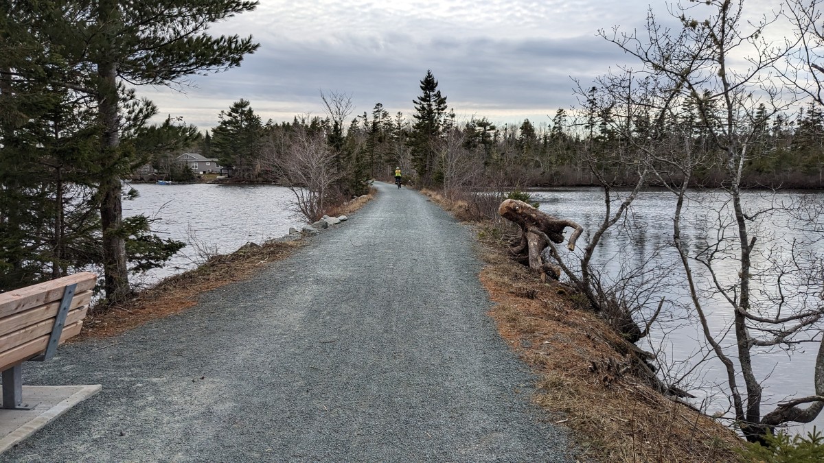 Cyclist in the distance seen riding across a causeway