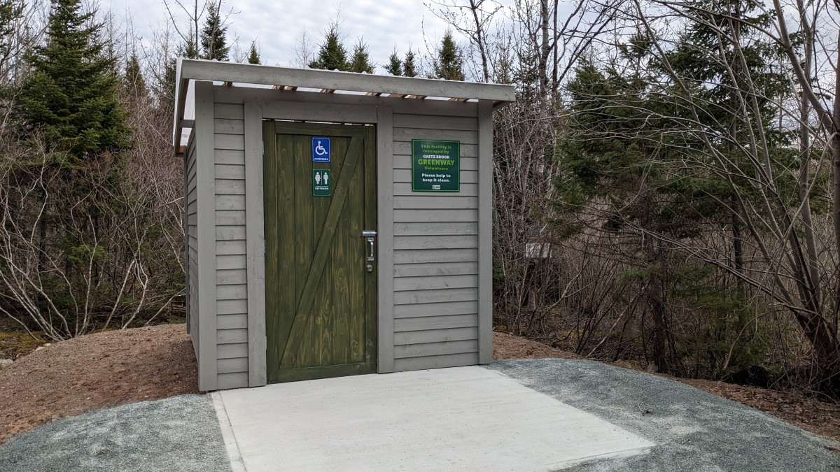 An accessuible outhouse with a newly constructed ramp