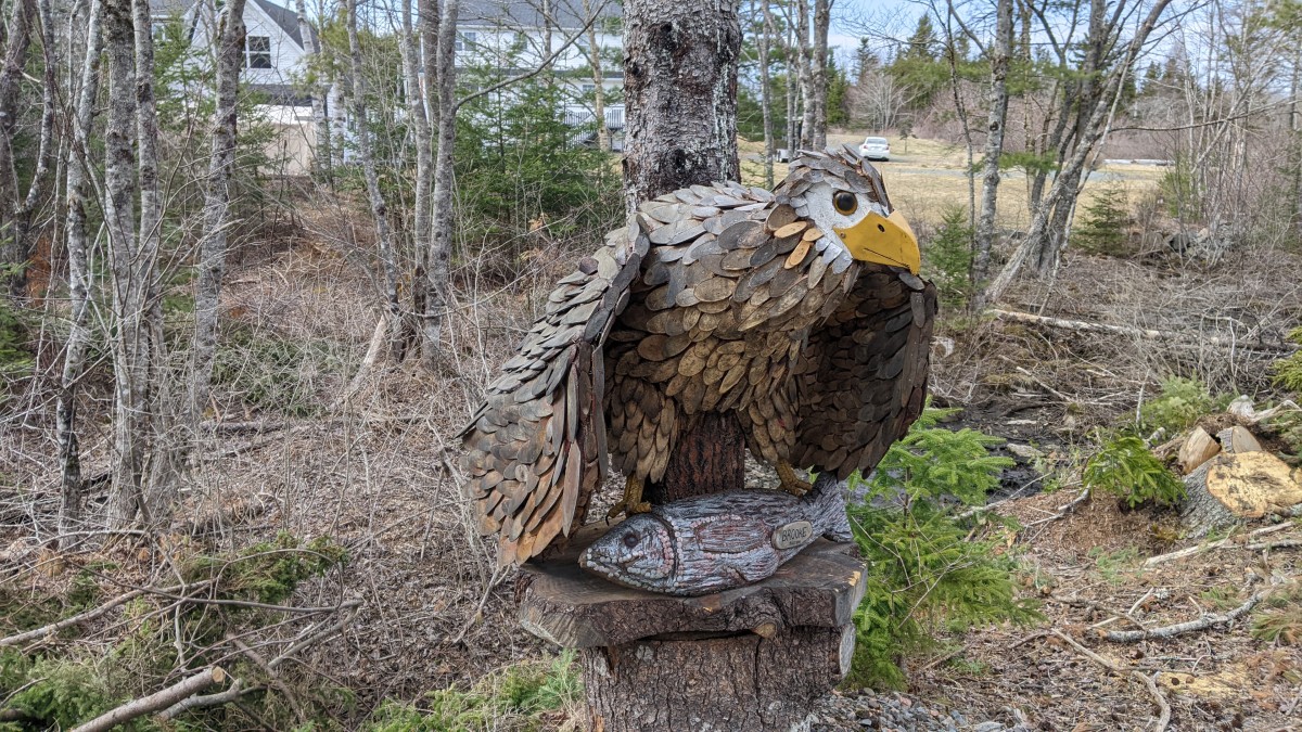 Wooden sculpture of an eagle with a fish in its claws