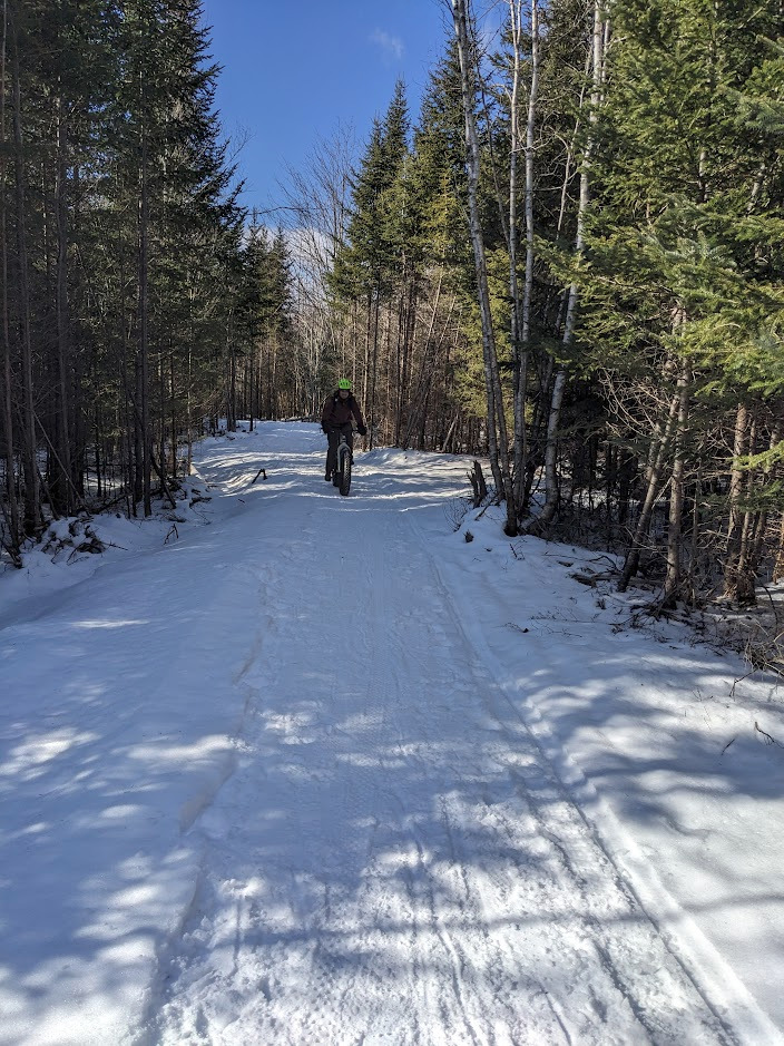 Adrien carefully rolls down a trail on his bike.
